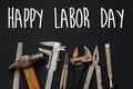 Happy labor day text sign. Working tools on black background top Royalty Free Stock Photo