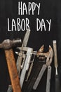 Happy labor day text sign. Working tools on black background top Royalty Free Stock Photo