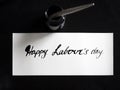 Happy labour`s day calligraphy and lattering post card. Top View with calligraph in ink tank