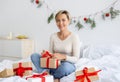 Happy lady celebrating Christmas unwrapping gift box Royalty Free Stock Photo