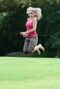 Happy lady in fifties jumping for joy