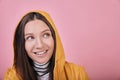 Happy lady with green eyes in yellow raincoat looks side and smiles Royalty Free Stock Photo