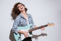 Happy lady holding guitar isolated over white background Royalty Free Stock Photo