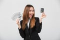 Happy lady smiling and showing cash dollars and credit card isolated Royalty Free Stock Photo