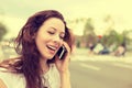 Happy lady talking on mobile phone walking on a street Royalty Free Stock Photo