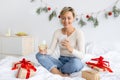 Happy lady using cellphone on Xmas drinking wine Royalty Free Stock Photo