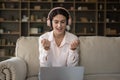 Happy laptop user in headphones staring at laptop screen Royalty Free Stock Photo