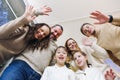 Happy large caucasian family with many children making selfie photo at home, waving hands at camera Royalty Free Stock Photo