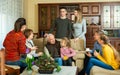 Happy large family gathered in parental home for family party, talking in cozy living room Royalty Free Stock Photo