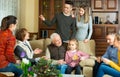 Happy large family gathered in parental home for family party, talking in cozy living room Royalty Free Stock Photo