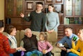 Happy large family gathered in parental home for family party, talking in cozy living room Royalty Free Stock Photo