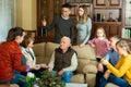 Happy large family gathered in parental home for family party, talking in cozy living room Royalty Free Stock Photo