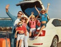 Happy large family in summer auto journey travel by car on beach