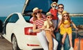 Happy large family in summer auto journey travel by car on beach