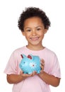 Happy latin child with a blue moneybox