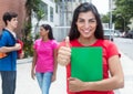 Happy latin female student in red shirt showing thumb Royalty Free Stock Photo