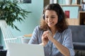 Happy latin girl student wearing headphones watching distance online class.