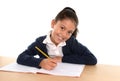 Happy latin little girl with notepad smiling in back to school and education concept Royalty Free Stock Photo