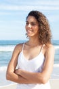 Happy latin woman with curly hair at beach Royalty Free Stock Photo