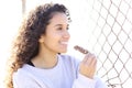 Happy latin woman eating a cereal bar outdoor Royalty Free Stock Photo