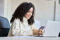 Happy latin young business woman using mobile phone working in office.. Royalty Free Stock Photo