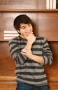 Happy latino-asian man in front of book shelf