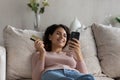 Happy Latino woman shopping online on cellphone Royalty Free Stock Photo