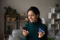 Happy Latino woman shopping online on smartphone Royalty Free Stock Photo