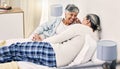 Happy, laugh and senior couple relax in bed with love, bond and holding hands with conversation. Old people, bedroom and Royalty Free Stock Photo