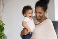 Happy African American mother holding adorable toddler daughter close up Royalty Free Stock Photo