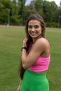 Happy laughing athletic brown-haired woman in pink top looks at camera during fitness classes.