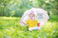 Happy laughing baby girl playing under umbrella Royalty Free Stock Photo