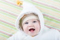 Happy laughing baby in a warm jacket with a funny hat Royalty Free Stock Photo