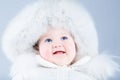 Happy laughing baby in a white winter jacket Royalty Free Stock Photo