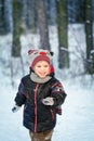 Happy laughing boy in a beautiful snowy winter forest Royalty Free Stock Photo