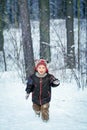 Happy laughing boy in a beautiful snowy winter forest Royalty Free Stock Photo