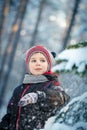 Happy laughing boy in a beautiful snowy winter forest Royalty Free Stock Photo