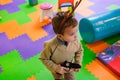 Boy having fun in kids amusement park and indoor play center. Child playing with colorful toys in playground. Royalty Free Stock Photo