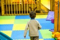 Boy having fun in kids amusement park and indoor play center. Child playing with colorful toys in playground. Royalty Free Stock Photo