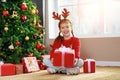 Happy laughing child girl with christmas present Royalty Free Stock Photo