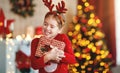 Happy laughing child girl with christmas present Royalty Free Stock Photo