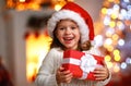 Happy laughing child girl with christmas present Royalty Free Stock Photo