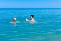 Girl is wearing inflatable armbands, learning to swim in the sea Royalty Free Stock Photo