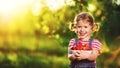 happy laughing child girl with ripe strawberry in summer on nature Royalty Free Stock Photo