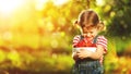 Happy laughing child girl with ripe strawberry in summer on nature Royalty Free Stock Photo