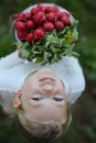 Happy laughing child with vegetables, fresh garden radish. Upside down