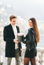 Man offering flower box of red roses to beautiful young woman Royalty Free Stock Photo