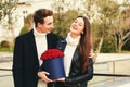 Man offering flower box of red roses to beautiful young woman Royalty Free Stock Photo