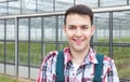 Happy laughing farmer in front of his greenhouse Royalty Free Stock Photo