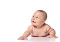 Happy laughing, giggling infant child baby girl kid in diaper is lying on her tummy holding arm outstretched Royalty Free Stock Photo